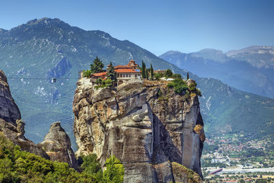 Panoramic view of buildings and mountain against sky