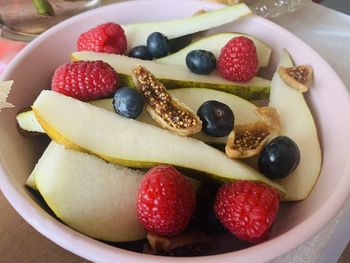 High angle view of strawberries and pears in bowl on table