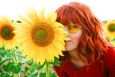 Portrait of woman with sunflower