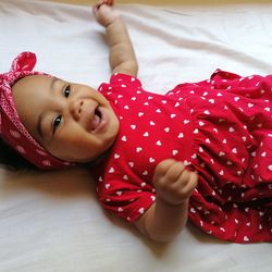 Portrait of cute girl lying on bed