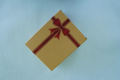 High angle view of gift box on blue background