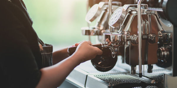 Midsection of woman working in coffee