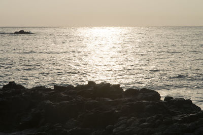 Scenic view of sea against clear sky during sunset