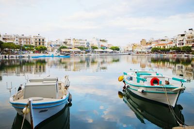 Boats in river with buildings in background