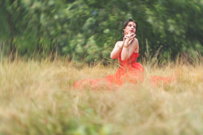 Midsection of woman on field