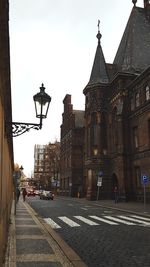 Street amidst buildings in city against sky