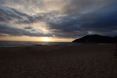 Scenic view of beach at sunset