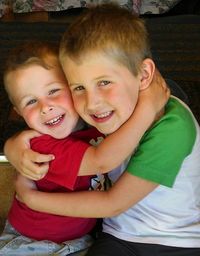 Close-up portrait of smiling boy and son