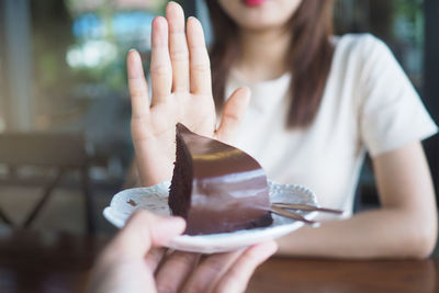 Midsection of woman holding ice cream