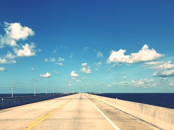 View of bridge over sea against blue sky