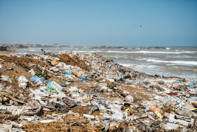 Garbage at beach against clear blue sky