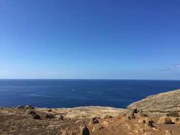 Scenic view of sea against clear blue sky