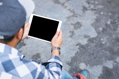 Low section of man using digital tablet