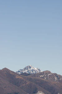 Scenic view of snowcapped mountains against clear blue sky