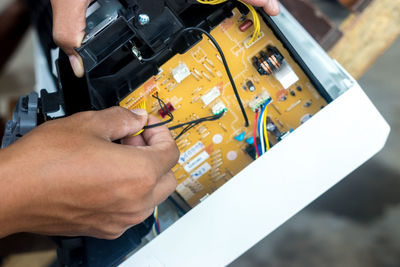 Midsection of man working on table