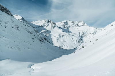 Scenic view of snowcapped mountains against sky