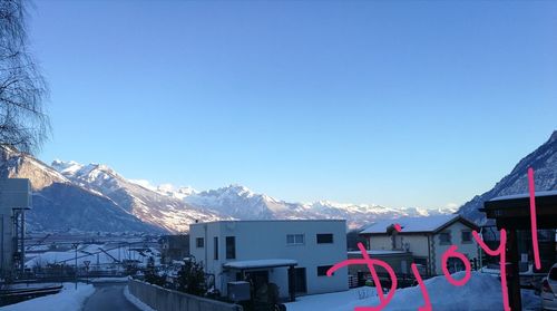 Snowcapped mountains against clear blue sky