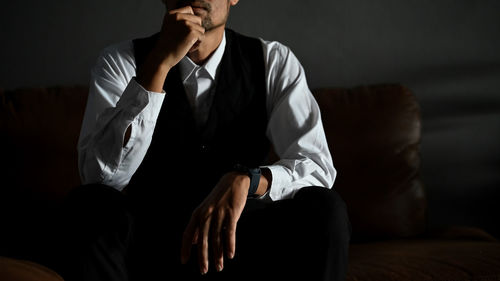 Low angle view of businessman using mobile phone