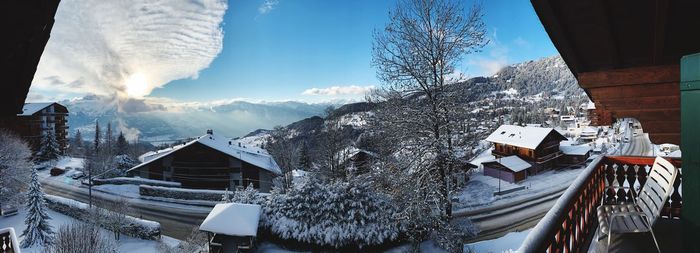 Panoramic view of snow covered buildings against sky