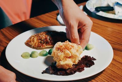 Close-up of man holding food on plate