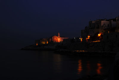 Illuminated buildings at waterfront