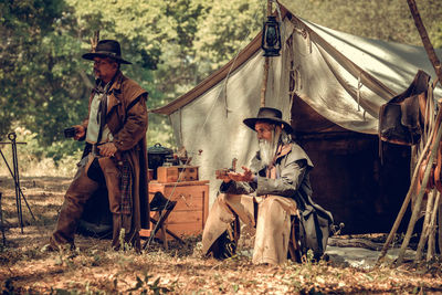 Men sitting in forest