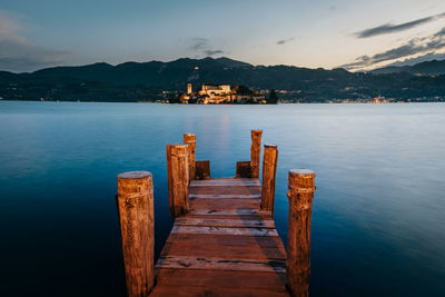 Pier over lake against sky