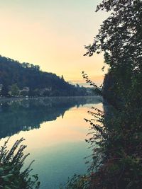 Scenic view of lake against sky at sunset