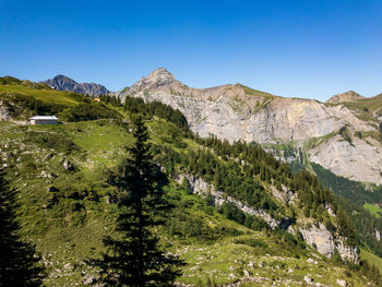 Scenic view of mountains against clear blue sky