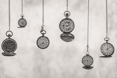 Close-up of pocket watches hanging side by side