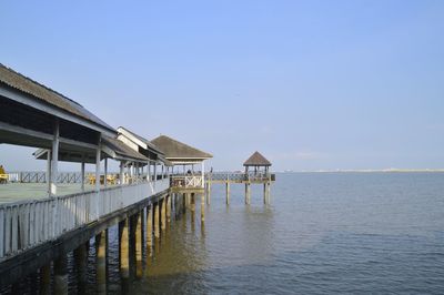 Pier over sea against clear sky