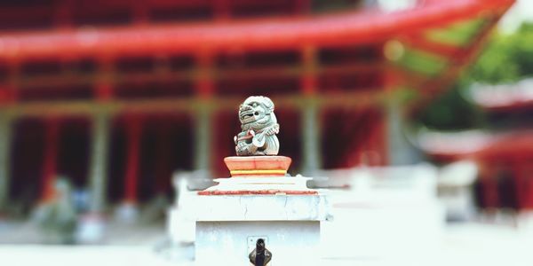 Close-up of small statue against blurred background