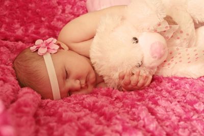 Close-up of cute baby sleeping on bed