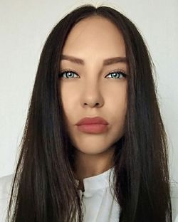 Close-up portrait of beautiful young woman over white background