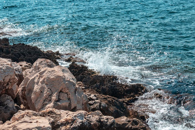 Sea waves splashing on rocks