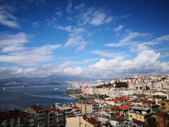 High angle view of townscape by sea against sky