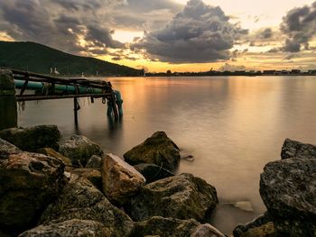 Scenic view of calm sea against sky at sunset