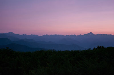 Scenic view of silhouette mountains against sky at sunset