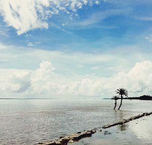 Scenic view of calm sea against cloudy sky