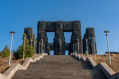 Low angle view of staircase against blue sky