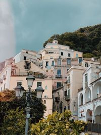 Low angle view of buildings and trees against sky