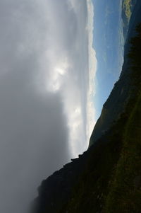 Scenic view of mountain against cloudy sky