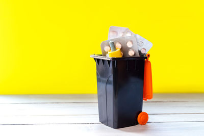 Close-up of yellow bottle against white background