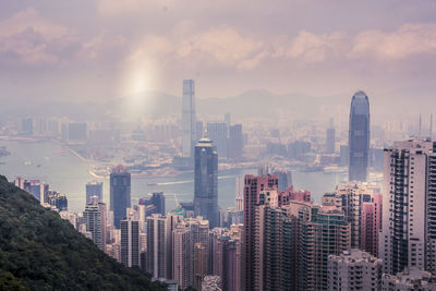 Aerial view of buildings in city against sky