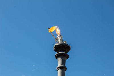 Low angle view of street light against blue sky