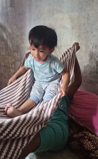 Full length of cute girl sitting