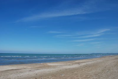 Scenic view of beach against blue sky