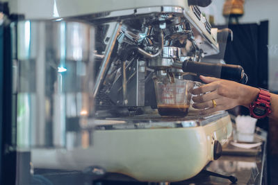 Hand holding coffee at cafe