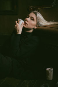 Midsection of man drinking coffee cup