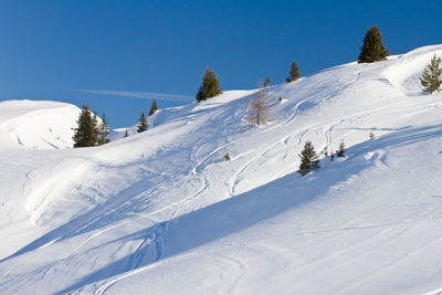 Winter landscape - ski tracks in powder snow, french alps, savoy